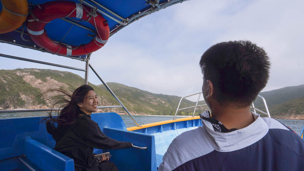 Two friends having a conversation on the speedboat en route to Ham Tin Beach.