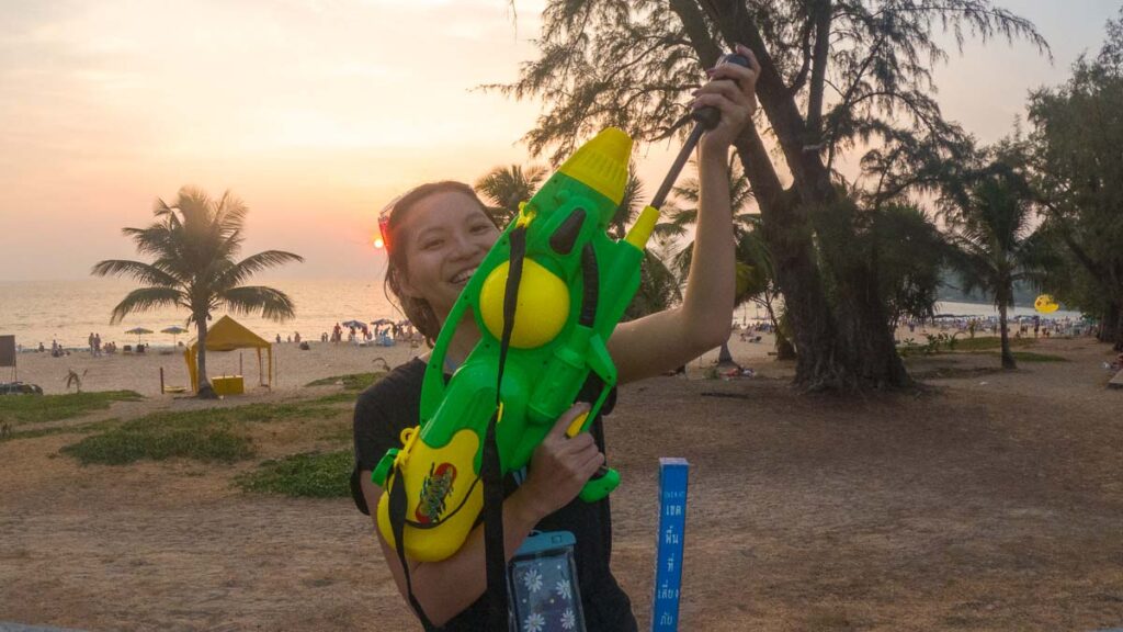 Girl with Water Gun at Beach - Guide to Songkran