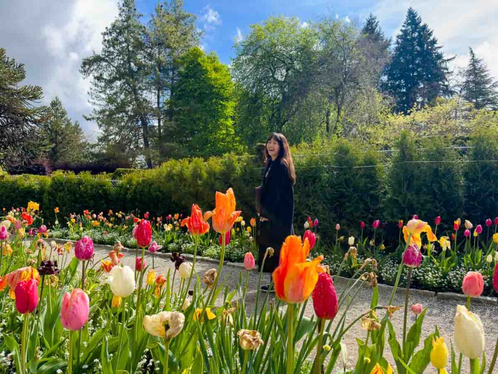 Girl walking amongst tulips in VanDusen Botanical Park - Canada attractions