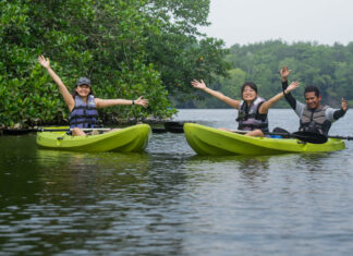 2D1N Desaru Itinerary — Exciting Things to Do on a Weekend Getaway that’s not JB People posing on Kayaks in Lebam River