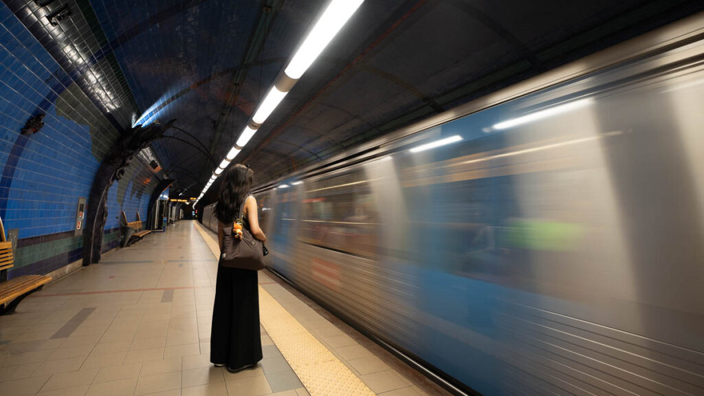 Girl waiting for the train at Parque Metro Station - Getting around Portugal