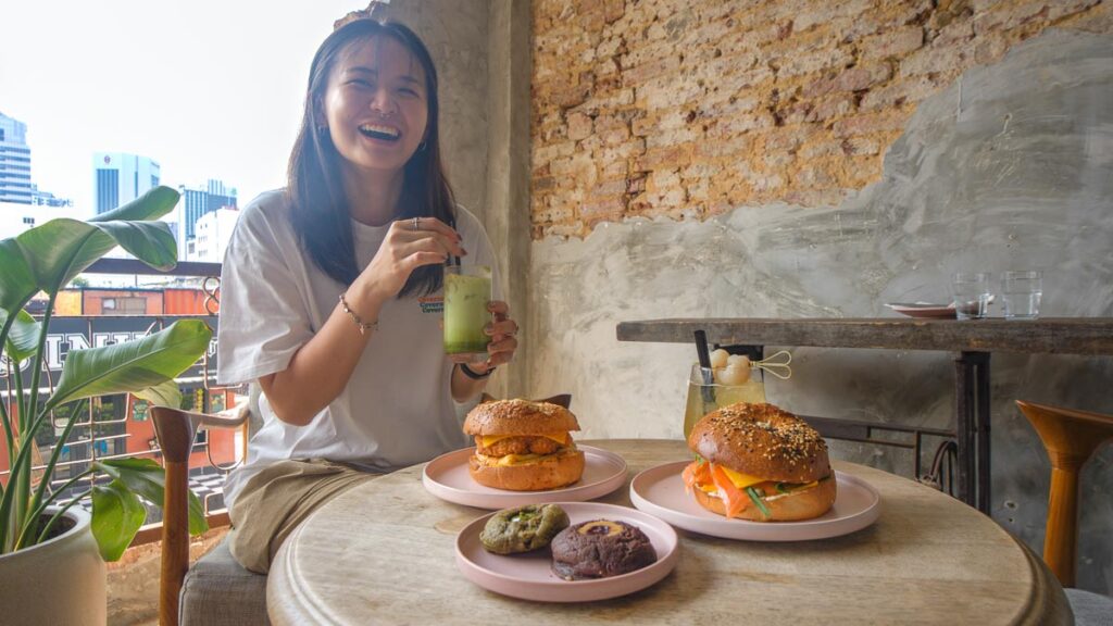 Girl Eating at Palates & Bagels Cafe - Things to eat in JB