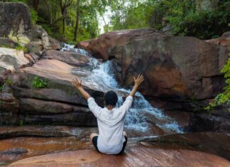 What to See, Eat and Do in Batu Ferringhi — Penang’s Beachside Alternative to George Town Boy In front of Iron waterfall - Things to do in penang