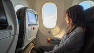 Girl sitting on airplane - South Australia guide