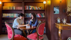 Friends reading inside the library at the Metropole Katoomba - Where to stay in the Blue Mountains
