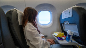 Girl sitting inside scoot plane - Sarawak guide