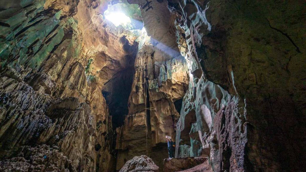 Woman standing in The Great Cave in Niah National Park - Sarawak guide