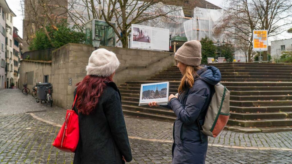 Guide explaining to participant on Zurich Old Town Walking Tour - Things to do in Zurich
