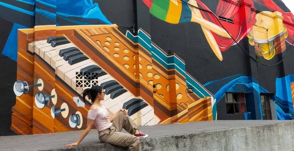 Girl posing in front of mural -Things to see in Jalan Tan Hiok Nee