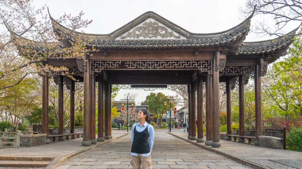 Girl standing before a Chinese pavillion at Guangfulin Cultural Relics Park - Hidden gems in Shanghai