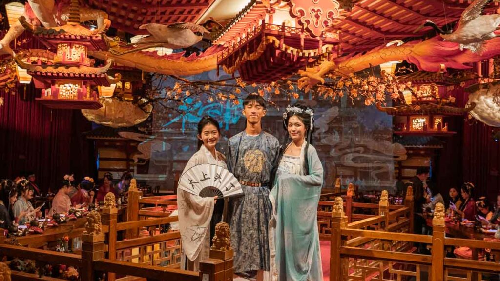 Taukee, Jensen, and Celeste taking a photo together on the Xuyan stage in their hanfu costumes - Shanghai tourist spots