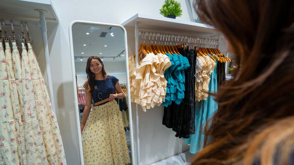 Girl posing in mirror with Bottled Dreams Clothes in JB Shopping Mall