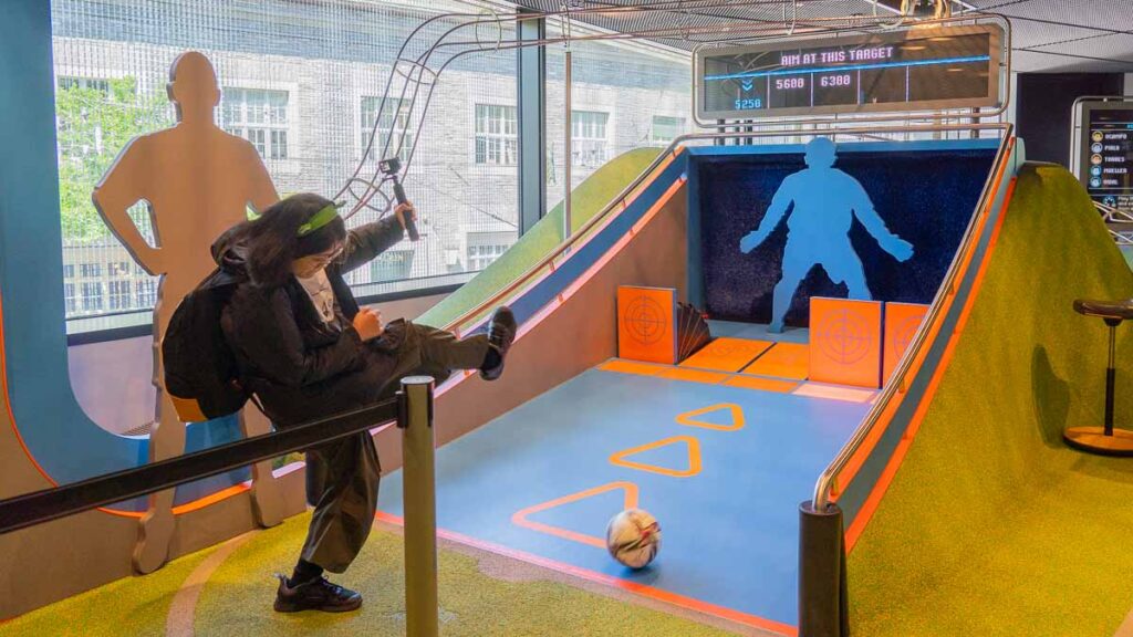 Tracey kicking a goal at the Pinball Area - What Locals Do In Zurich