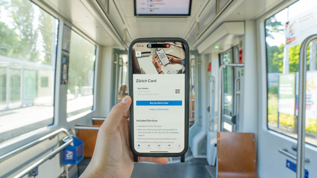 A hand holding the zurich card in public transport - Zurich Card