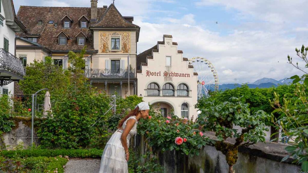 Su smelling roses in the Old Town, Rapperswil - Switzerland Guide