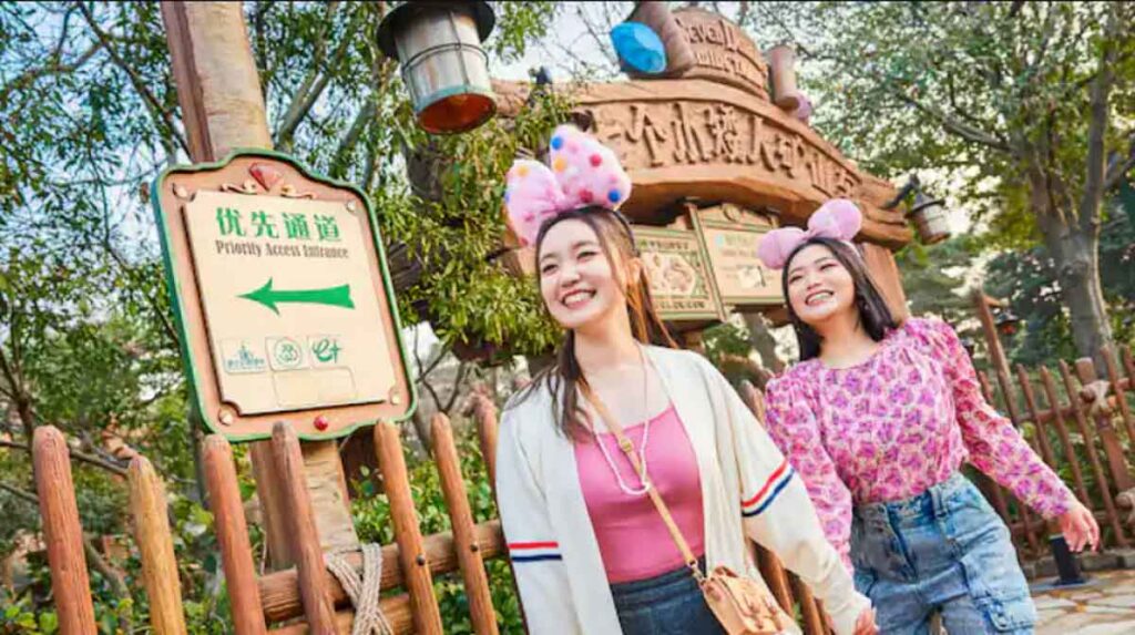 Photo of two girls walking past an attraction in Shanghai Disneyland - Shanghai Disneyland