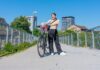 Girl posing with her bike on a bridge - Biking in Zurich