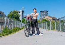 Girl posing with her bike on a bridge - Biking in Zurich