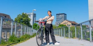 Girl posing with her bike on a bridge - Biking in Zurich