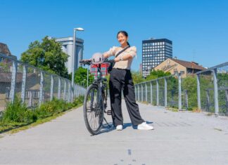 Girl posing with her bike on a bridge - Biking in Zurich