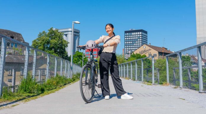 Girl posing with her bike on a bridge - Biking in Zurich