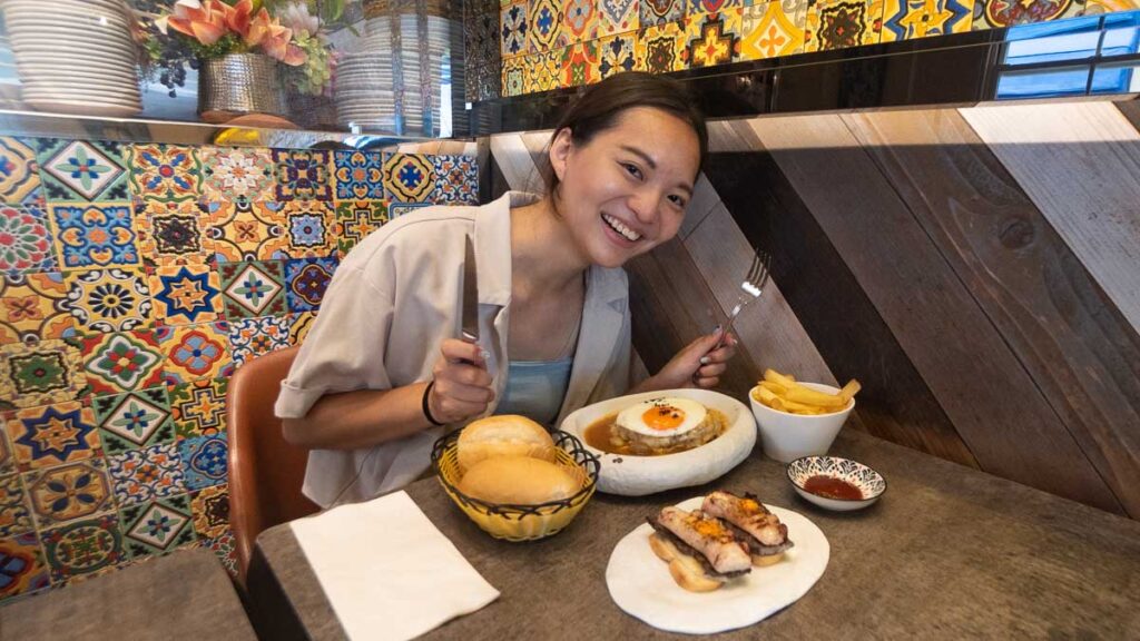 Girl Eating Food at Tapas de Portugal - Things to Eat in Macao