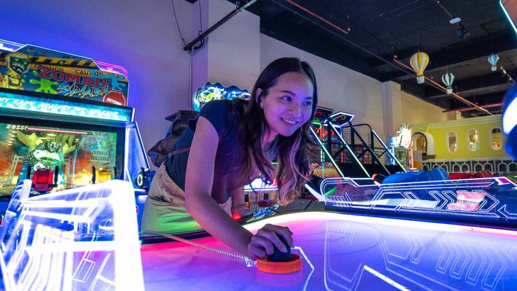 girl playing air hockey FUNTOPIA - KSL city mall