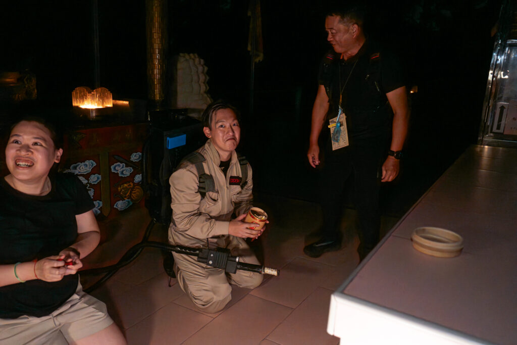 Boy in ghostbusters costume kneeling at altar
