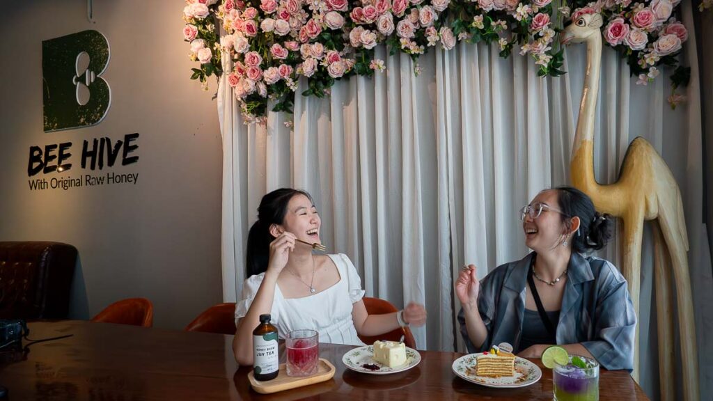 2 people enjoying honey cakes at Bee Hive Honey Cafe