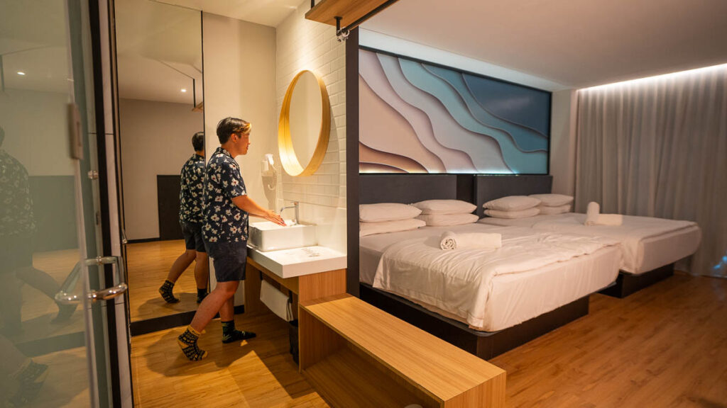 Theon using the sink in his room at Hako Hotel - Affordable jb hotels