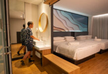 Theon using the sink in his room at Hako Hotel - Affordable jb hotels
