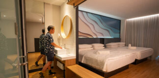 Theon using the sink in his room at Hako Hotel - Affordable jb hotels