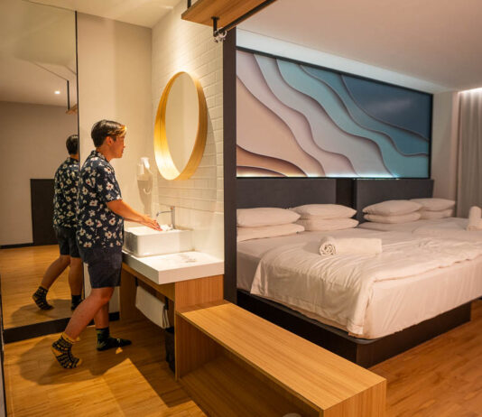 Theon using the sink in his room at Hako Hotel - Affordable jb hotels