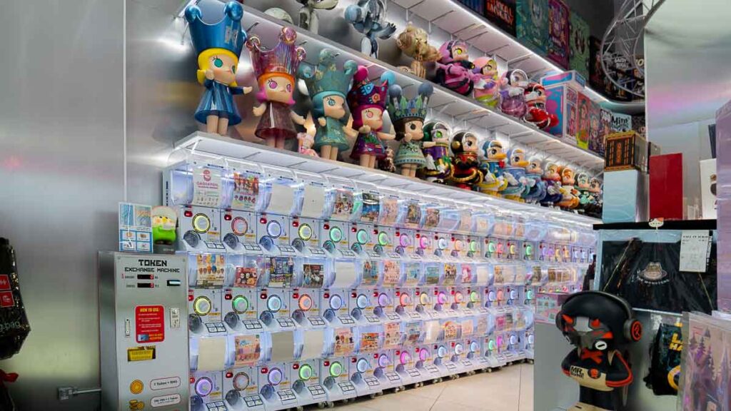 Gacha Machines of Impulse Gaming with huge figurines lining the shelves on top
