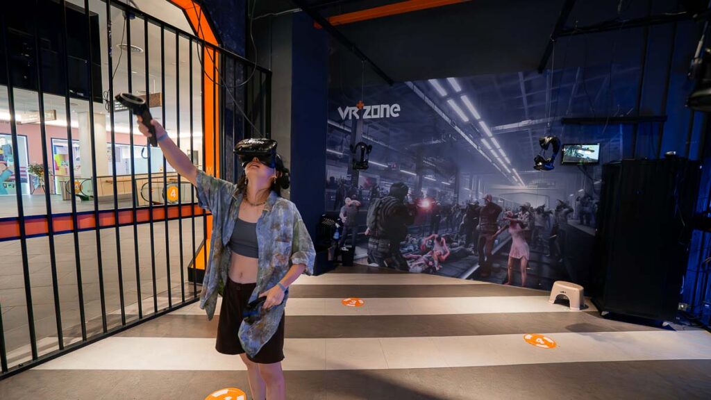 Person immersed in a VR game at VR+ Zone