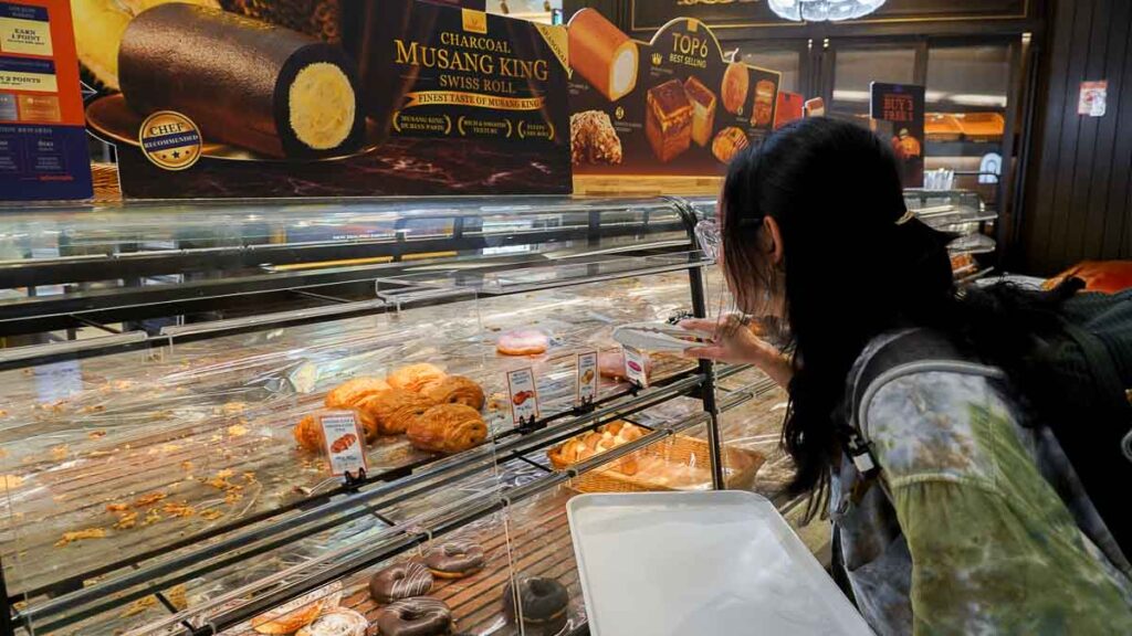 Person choosing bread at Verrona Hills Bread & Pâtisserie Bakery