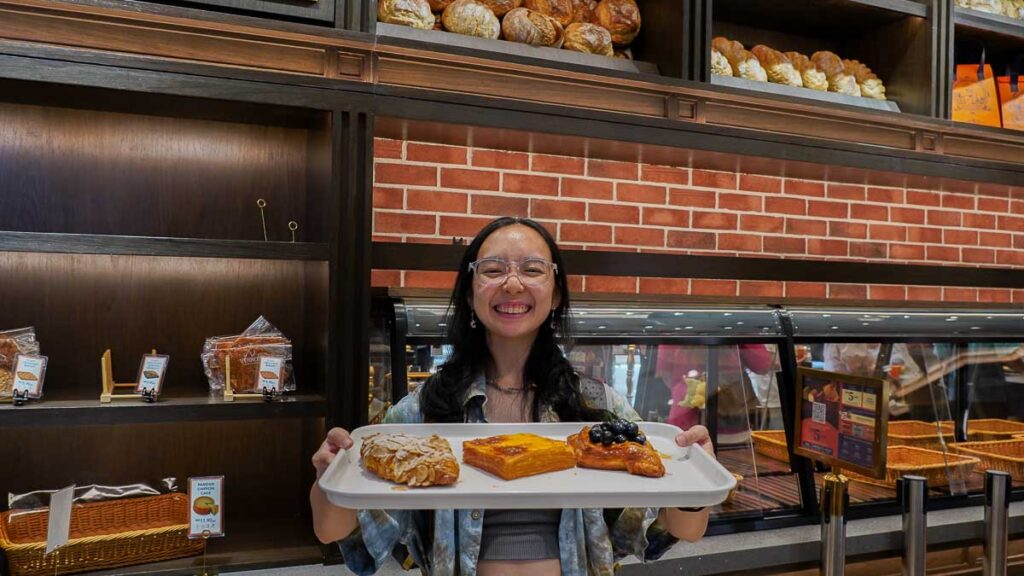 Person holding a tray with bread at Verrona Hills Bread & Pâtisserie Bakery