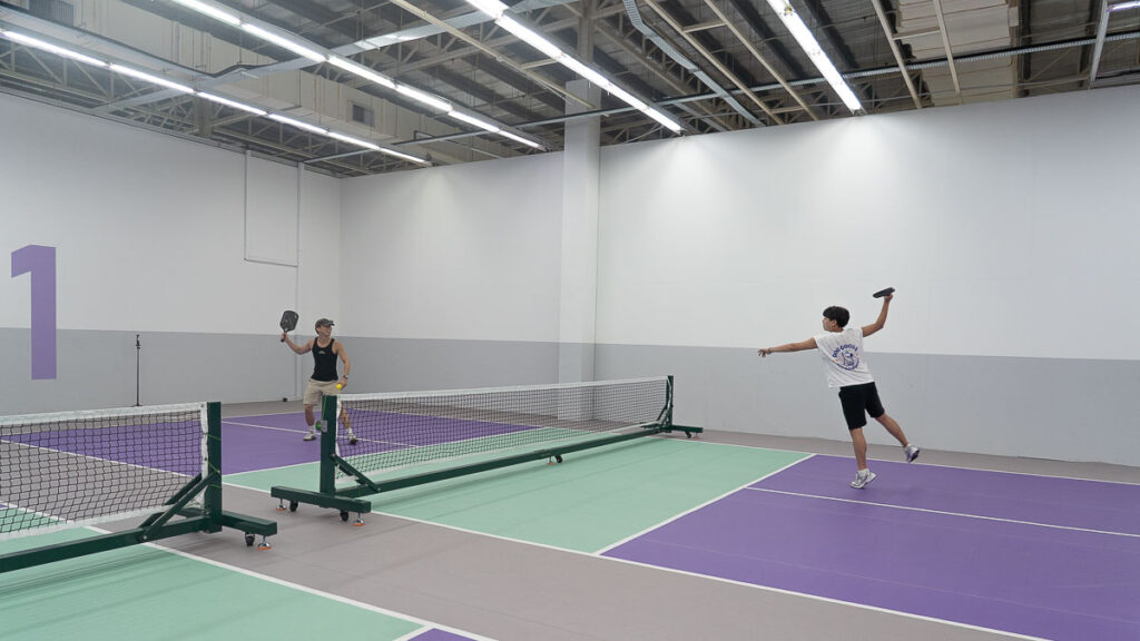 2 people playing pickleball