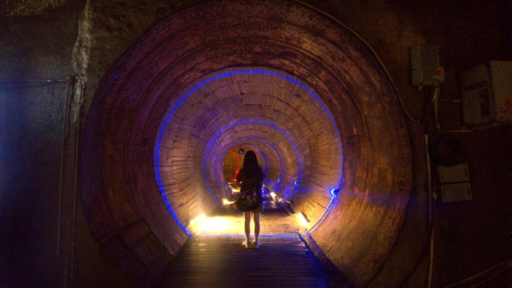 Girl Walking Through 816 Nuclear Plant Tunnel - Chongqing Itinerary