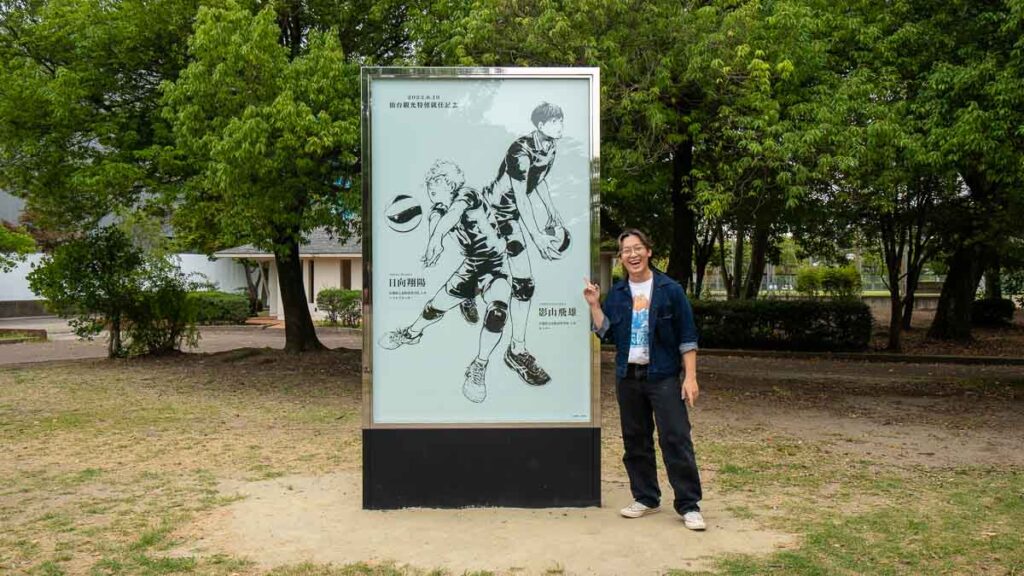 Boy standing in front of haikyu!! monument - tohoku summer itinerary