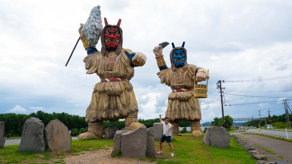 Boy standing in front of Namahage Statue, Oga Penninsula, Akita, Japan - Tohoku Summer Itinerary
