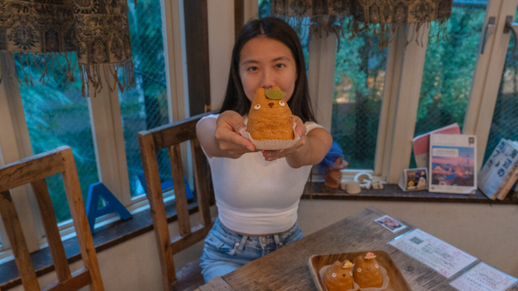 Girl holding totoro puff in Shorihiges Cream Puff Factory – Hakone Itinerary
