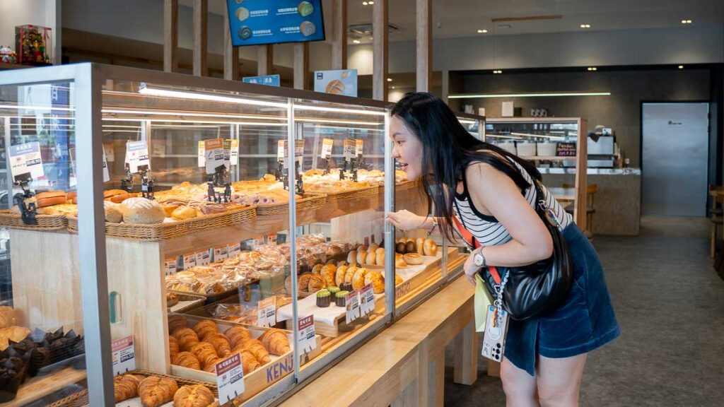 Person choosing bread at Kenjo Bakery Mount Austin