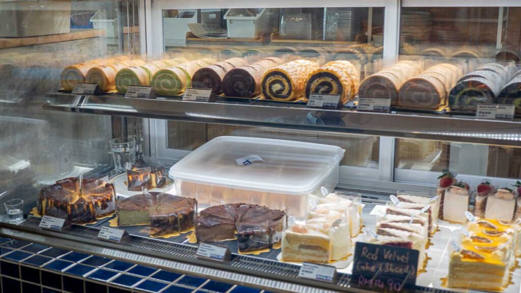 Cake display featuring Basque Burnt Cheesecake and Swiss Rolls at Kenjo Bakery Mount Austin