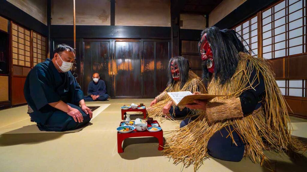 Man sitting with Namahage, Namahage Museum, Oga Peninsula, Akita, Japan - Tohoku Summer Itinerary