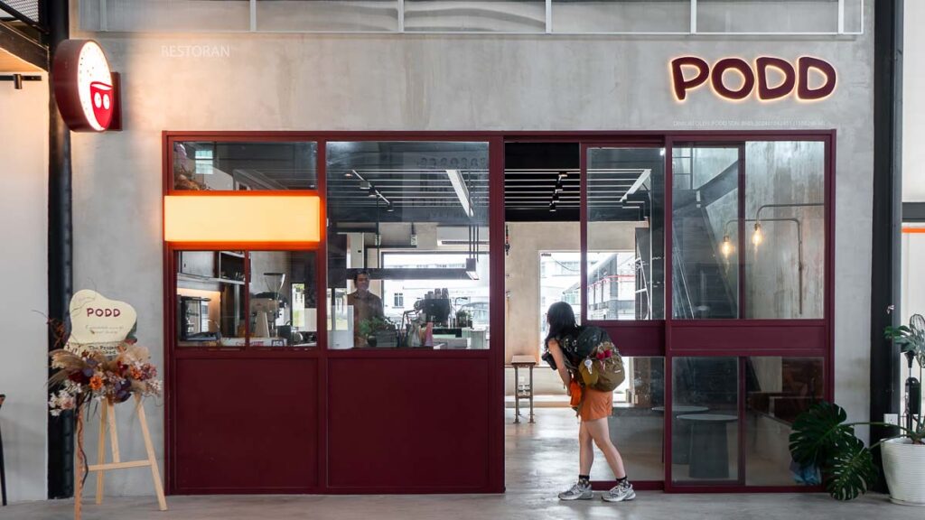Person peeking into the cafe at Podd Cafe Mount Austin