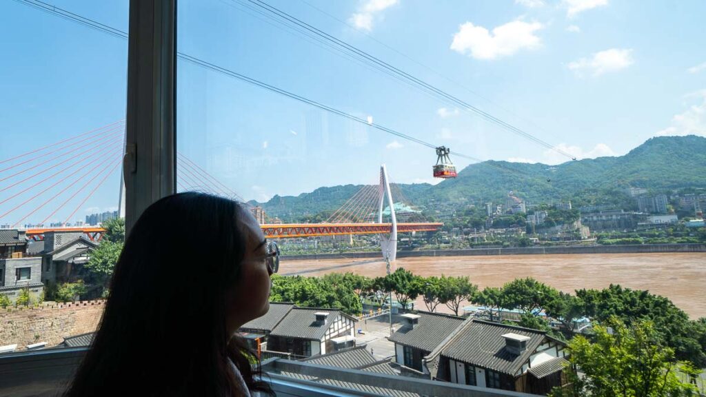 Girl at Shanshiji Looking at Yangtze Ropeway Window View - Chongqing Itinerary