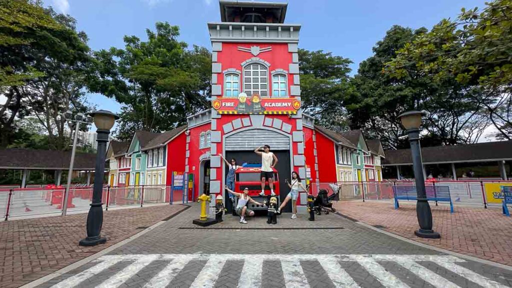 4 people posing in front of Legoland Fire Academy - Things to do in Legoland Malaysia