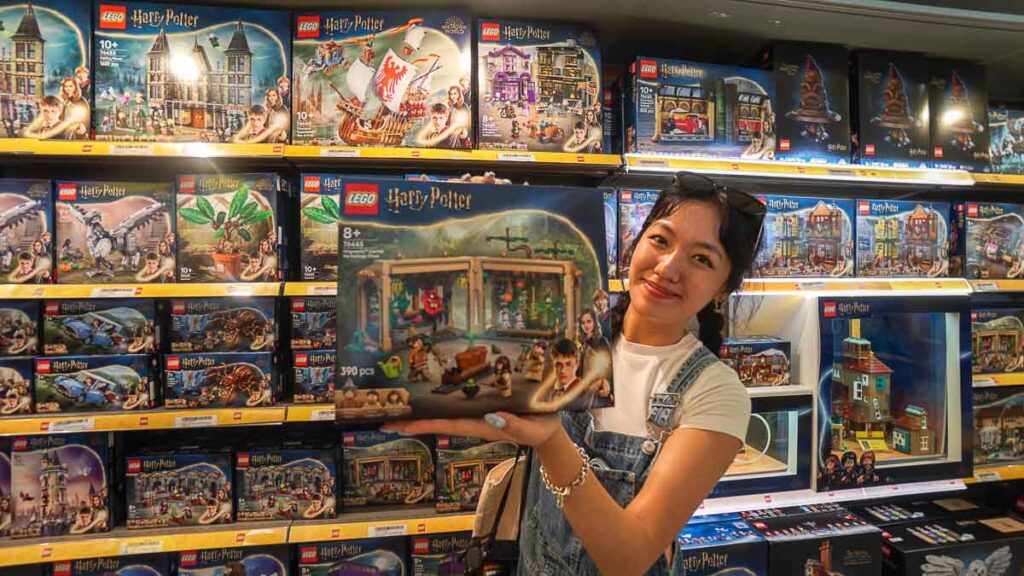 girl smiling holding Harry Potter lego set - Things to do in Legoland Malaysia