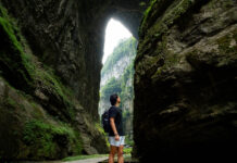 Person looking at the Three Natural Bridges at Wulong Karst